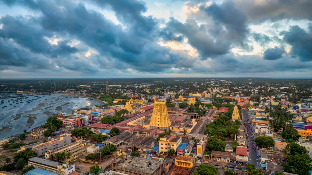 A stunning aerial view of Rameswaram, TN, India showcasing its iconic temples against a dramatic sky.